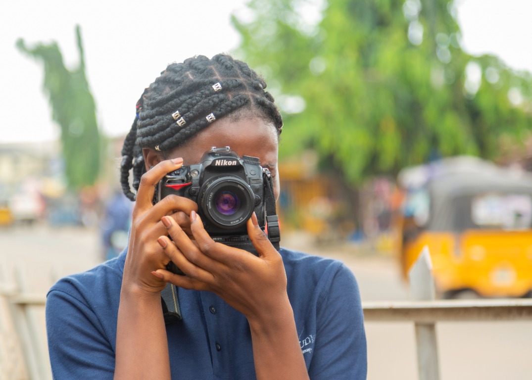 Academy student photographing with a camera