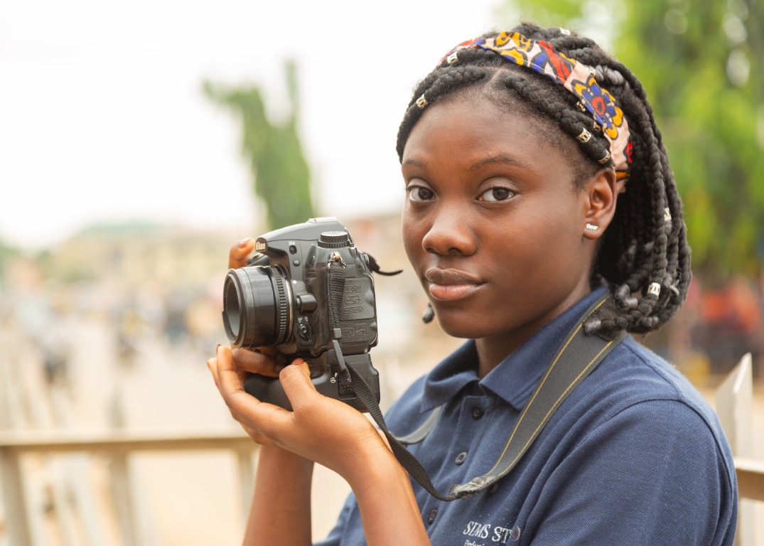 Academy student holding a camera