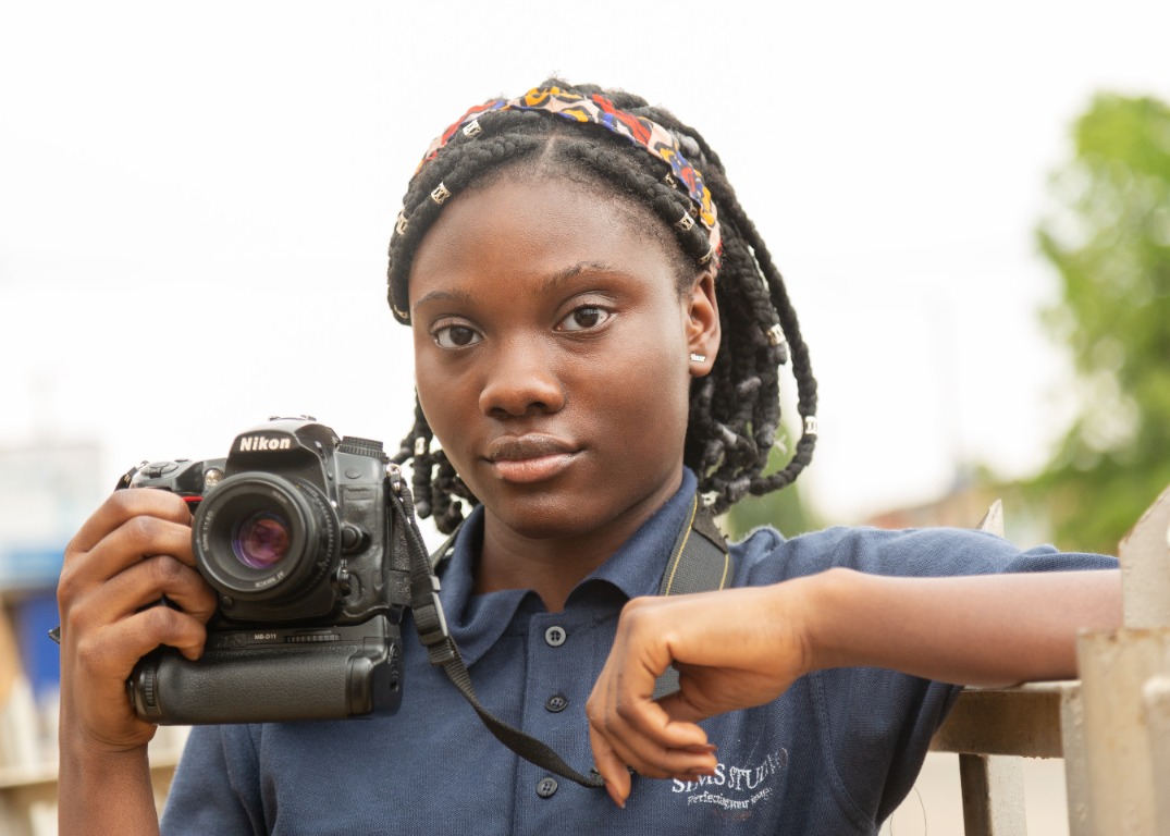 Academy student posing with a camera