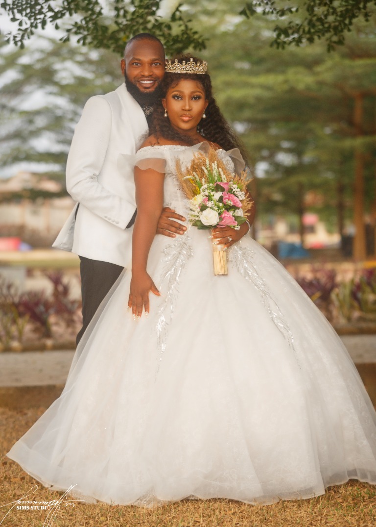 Bride and groom in white wedding attire